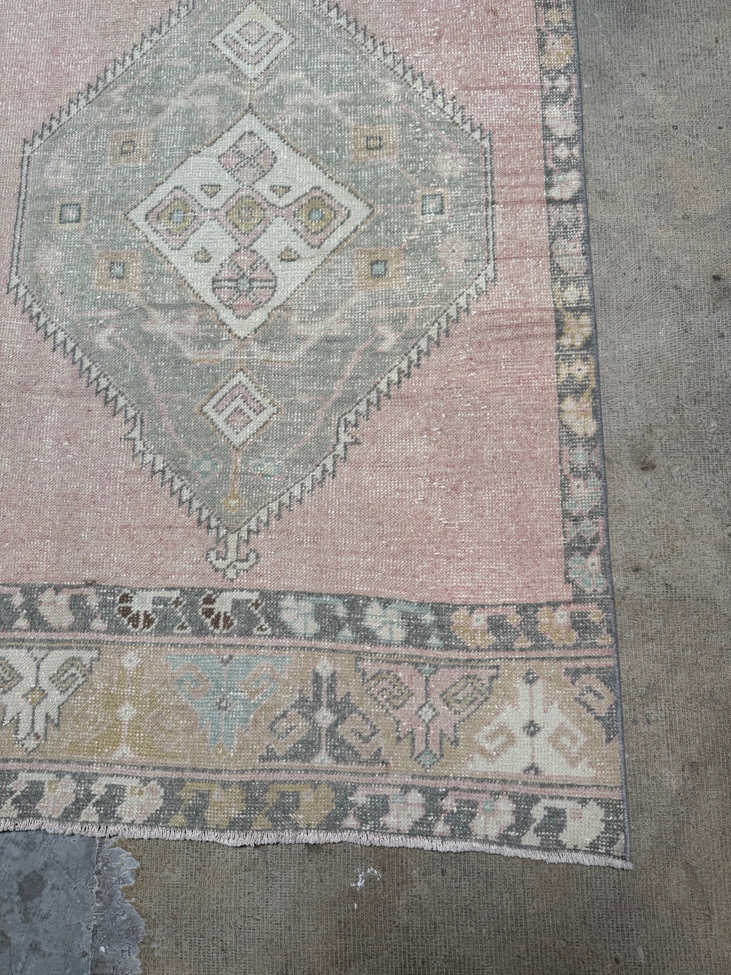 vintage rug with geometric pattern on a concrete floor